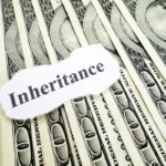 Inheritance note over pile of hundred dollar bills