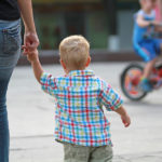 Mother holding boys hand