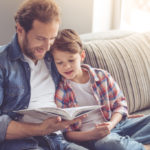 Father and son reading together