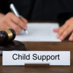 Attorney at desk with child support sign on it