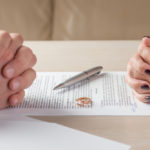 Married couple signing a form