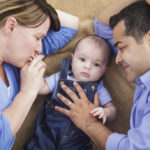 a co-parent playing with a baby