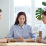 Unhappy married couple sitting opposite getting divorced in lawyer office