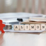 Word ALIMONY composed of wooden letters.