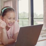 Asian girl making facetime video calling with laptop, using zoom learning online app, home based remotely learning social distancing, isolation, homeschooling education, learning remotely, new normal