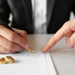 Man signing marriage contract, closeup