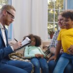 Child protection services worker visiting caucasian woman with two adopted children