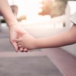 mom holding daughter hand