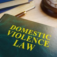 Domestic violence law on a wooden table.