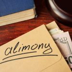 Alimony concept. An envelope with cash on a table.