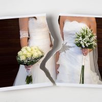 Divorce concept. Torn photograph of a lesbian couple at their wedding